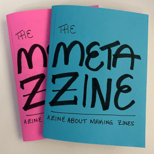 two assembled copies of 1/4 size "The Meta Zine: A Zine About Making Zines"